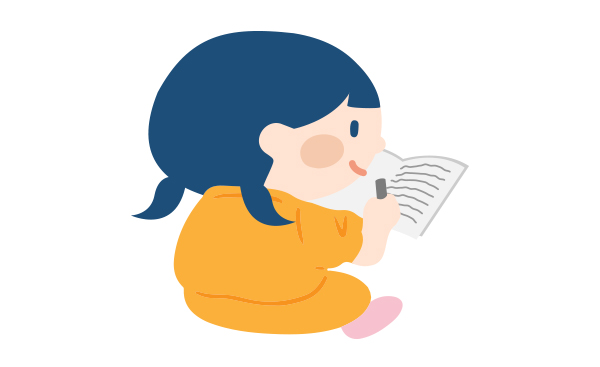 子どもがノートに物語を描いている